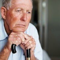 Depressed elderly man lost in thought