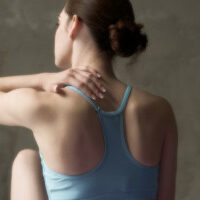 a woman with neck pain