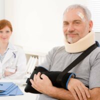Senior patient broken arm in doctor office Senior patient broken arm in doctor office